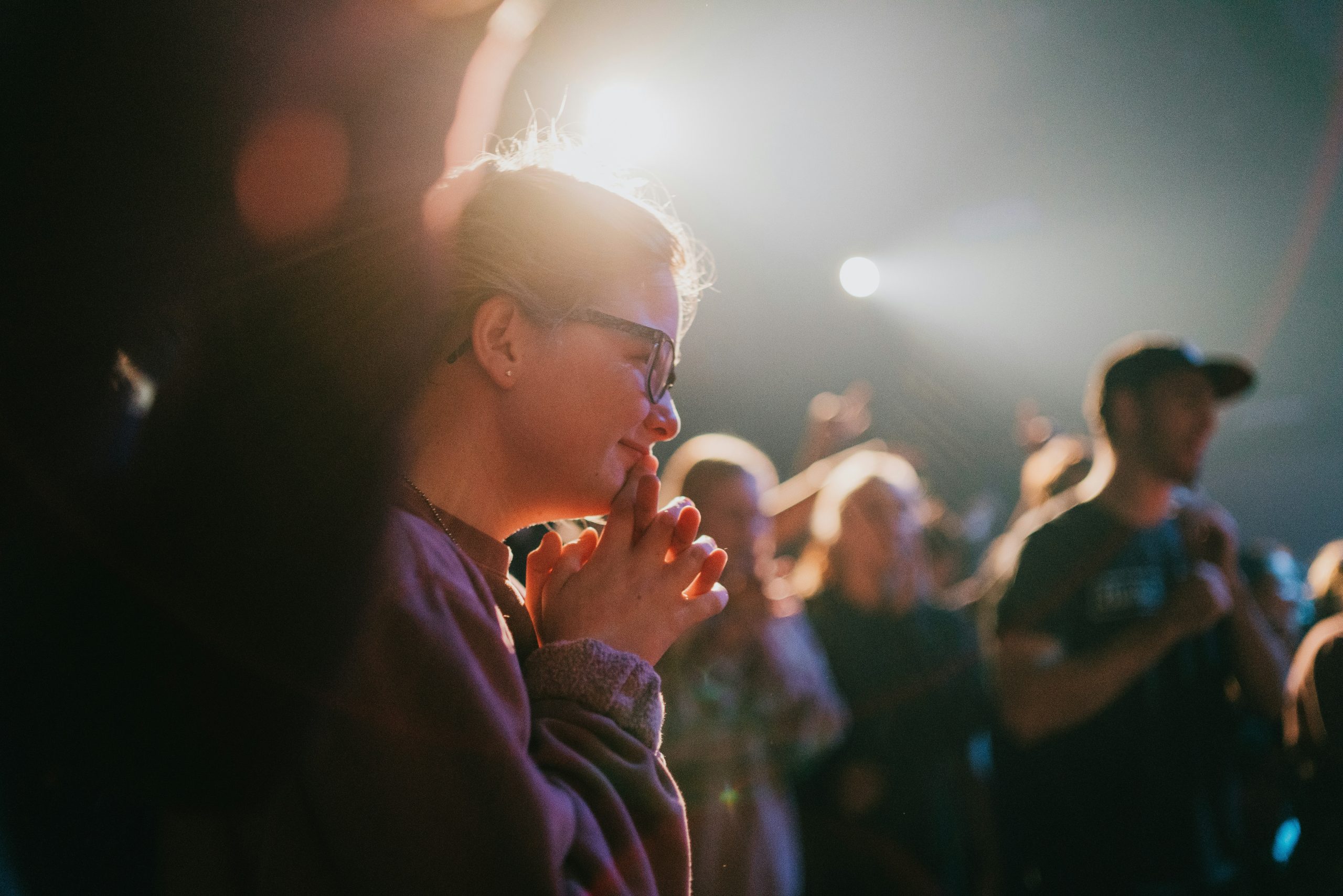 Church members praying together during a service at St Paul's Shellharbour